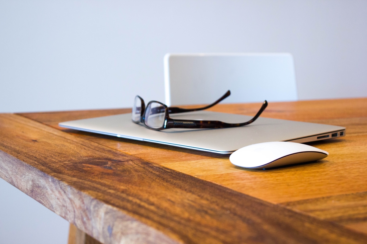 Desk with laptop and glasses